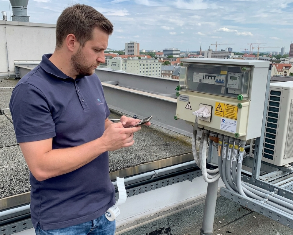 Surveyor with phone on rooftop